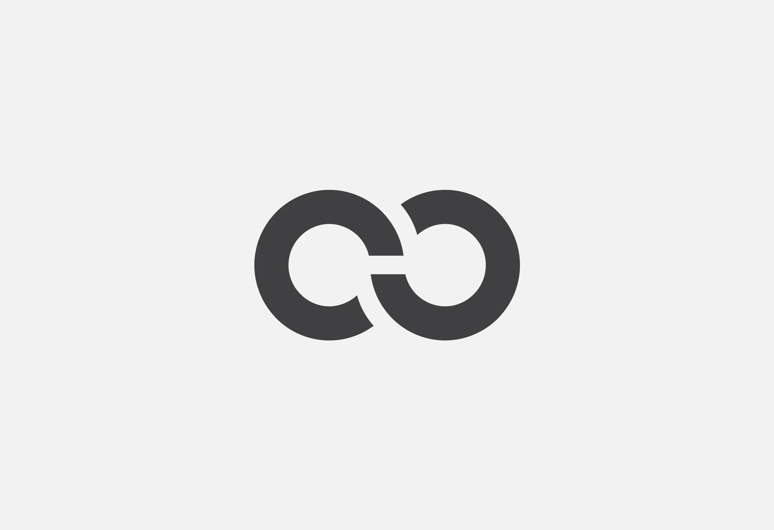 Color Glos symbol: två sammanlänkade ringar som bildar en evighetssymbol, i mörkgrått